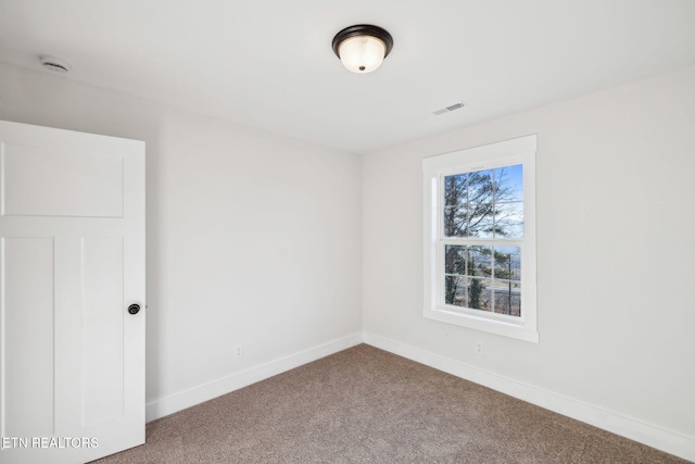 unfurnished room featuring visible vents, baseboards, and carpet