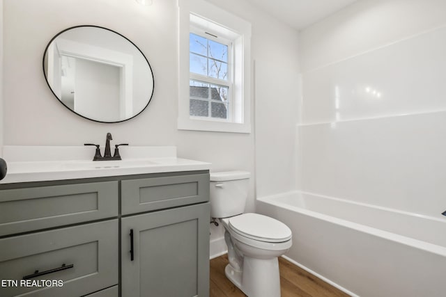 bathroom featuring vanity, toilet, and wood finished floors