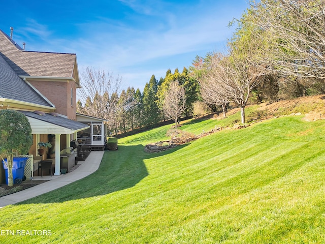 view of yard featuring a patio and a sunroom