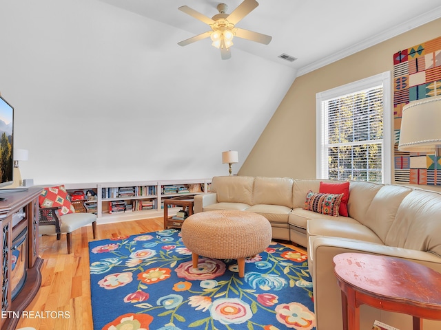 living area featuring visible vents, wood finished floors, crown molding, ceiling fan, and vaulted ceiling