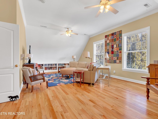 living room with visible vents, crown molding, a ceiling fan, and wood finished floors