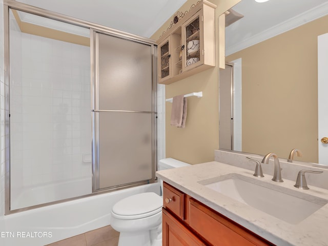 bathroom with crown molding, toilet, tile patterned floors, vanity, and enclosed tub / shower combo