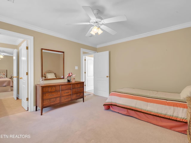 bedroom featuring a ceiling fan, baseboards, light colored carpet, and crown molding