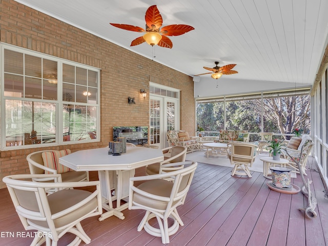 sunroom / solarium with lofted ceiling and ceiling fan