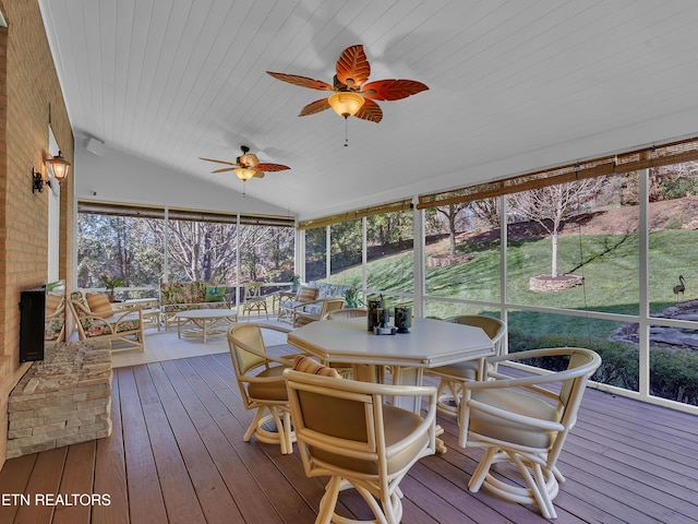 sunroom / solarium featuring lofted ceiling, wood ceiling, and ceiling fan