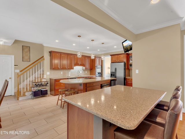 kitchen featuring a spacious island, backsplash, stainless steel fridge with ice dispenser, ornamental molding, and a kitchen breakfast bar