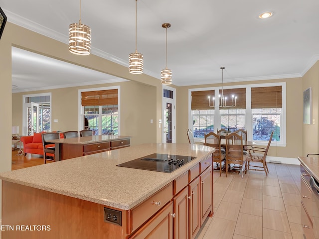 kitchen featuring ornamental molding, black electric cooktop, light stone countertops, and a kitchen island