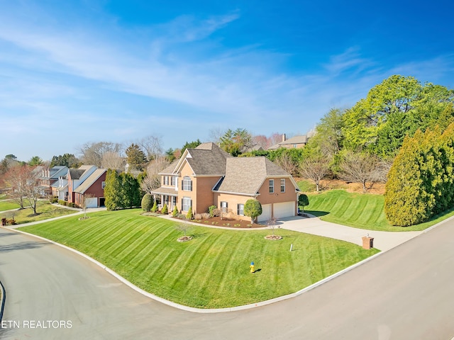 view of front of house featuring a front lawn and driveway