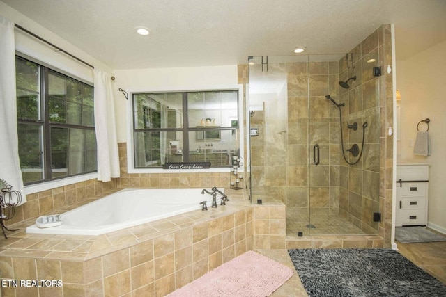 full bath featuring a bath, plenty of natural light, a shower stall, and tile patterned floors