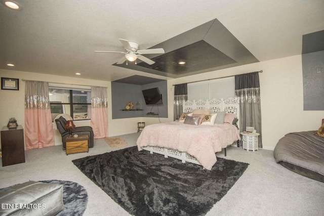 bedroom with recessed lighting, a tray ceiling, carpet floors, and a ceiling fan