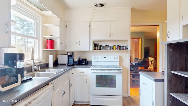 kitchen featuring open shelves, a wealth of natural light, white appliances, and a sink