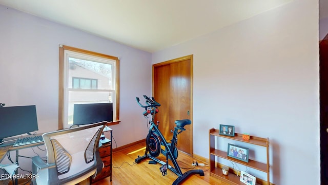 home office with wood finished floors and baseboards