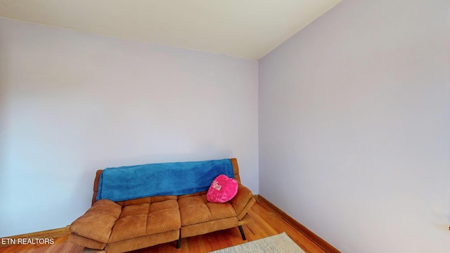 sitting room with wood finished floors and baseboards