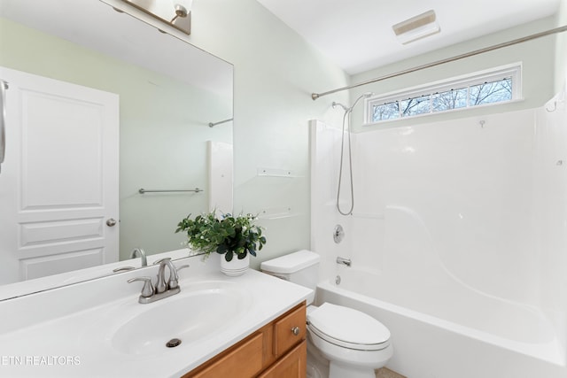 bathroom with toilet, vanity, and shower / bathing tub combination