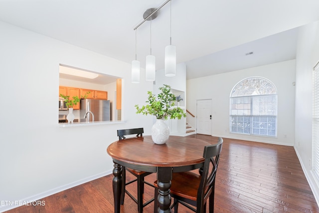 dining area with visible vents, stairs, dark wood-type flooring, and baseboards