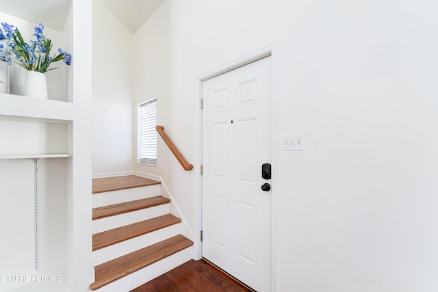 interior space with dark wood-style floors and stairs