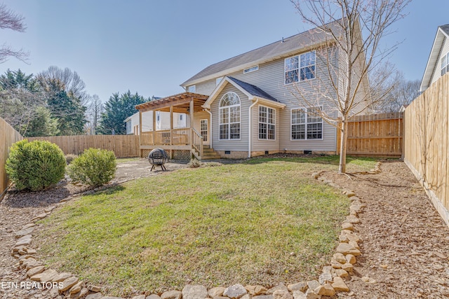 rear view of property with crawl space, a yard, a patio, and a fenced backyard