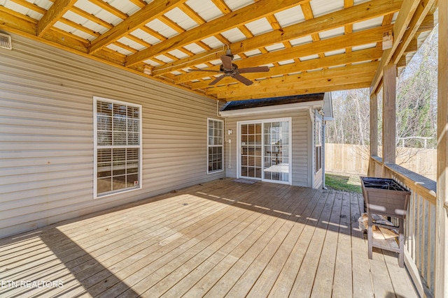 deck with ceiling fan and fence