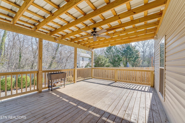 wooden terrace featuring a ceiling fan