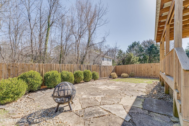 view of patio with a fenced backyard and an outdoor fire pit