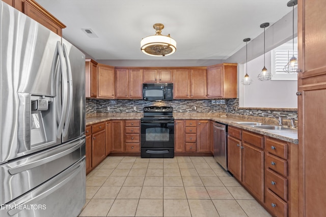 kitchen with visible vents, a sink, decorative backsplash, black appliances, and brown cabinets