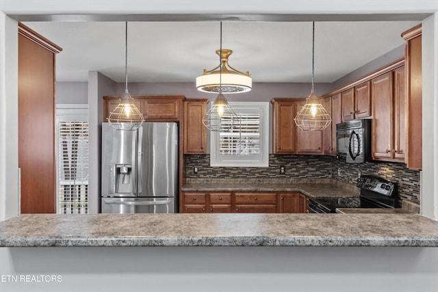 kitchen with brown cabinetry, decorative backsplash, pendant lighting, and black appliances