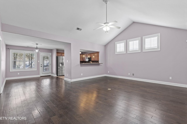 unfurnished living room with baseboards, visible vents, dark wood finished floors, ceiling fan, and vaulted ceiling