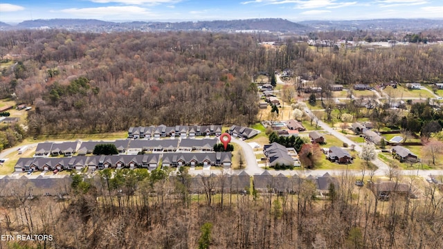 birds eye view of property featuring a forest view and a residential view