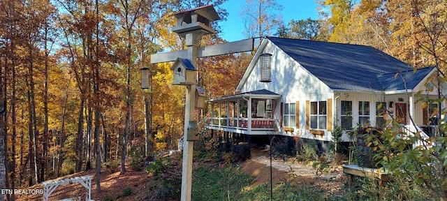 view of side of home with a sunroom