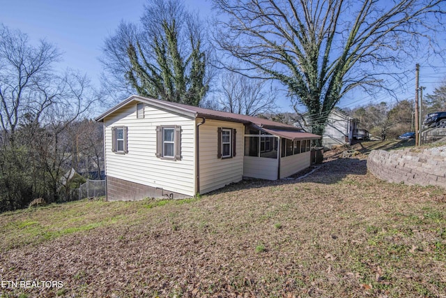 view of side of home featuring a lawn