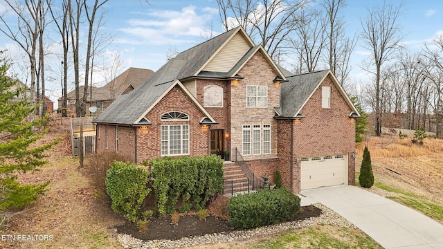 view of front of house with brick siding, driveway, an attached garage, and a shingled roof