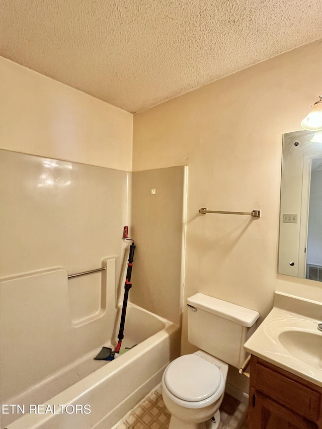 full bath with tile patterned floors, a textured ceiling, toilet, and vanity