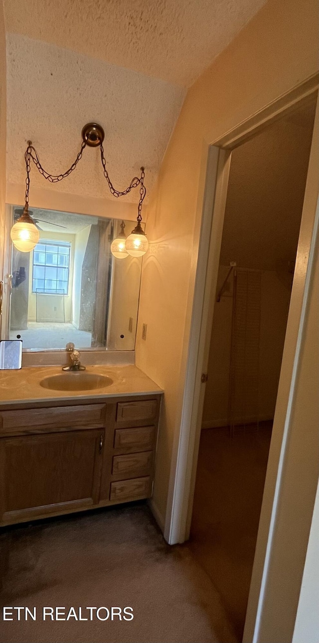 bathroom featuring a textured ceiling and vanity