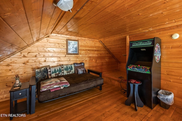 bedroom featuring vaulted ceiling, wood ceiling, wooden walls, and hardwood / wood-style flooring