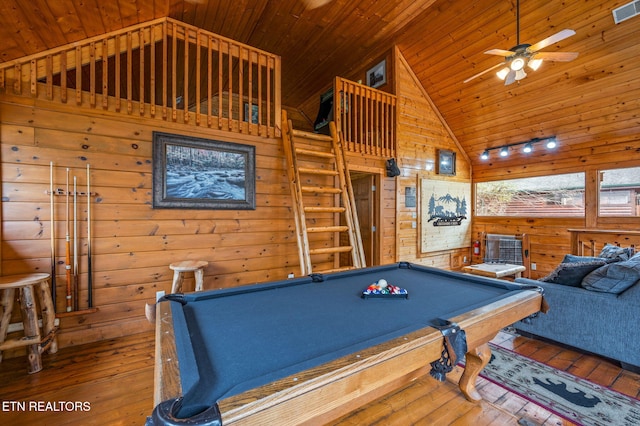 playroom with wooden walls, wood ceiling, wood-type flooring, and high vaulted ceiling