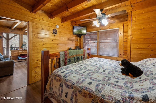 bedroom with beamed ceiling, wooden walls, wood finished floors, and wooden ceiling