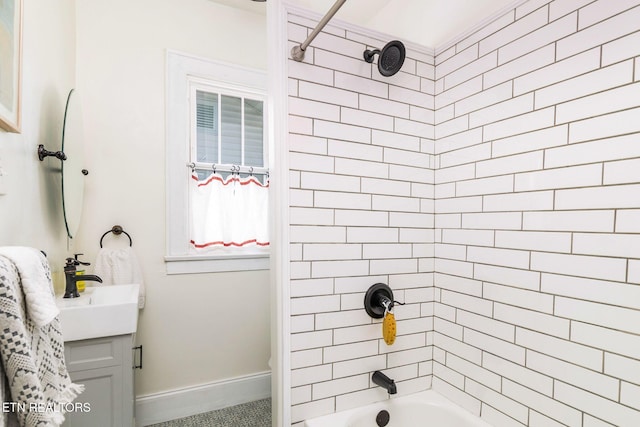 bathroom with baseboards, bathing tub / shower combination, and vanity