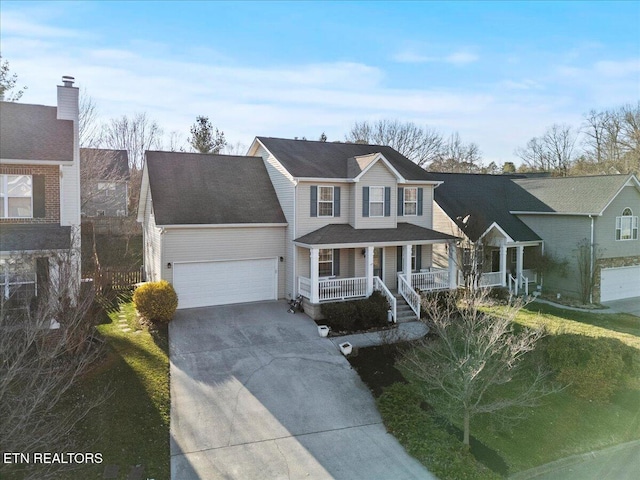 view of front of home featuring a garage, covered porch, and concrete driveway