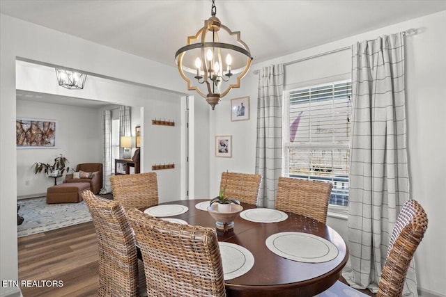 dining area with an inviting chandelier and wood finished floors