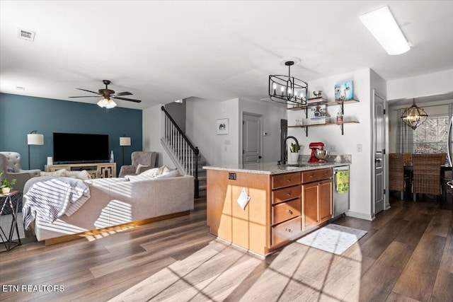 kitchen featuring open shelves, visible vents, wood finished floors, and a sink