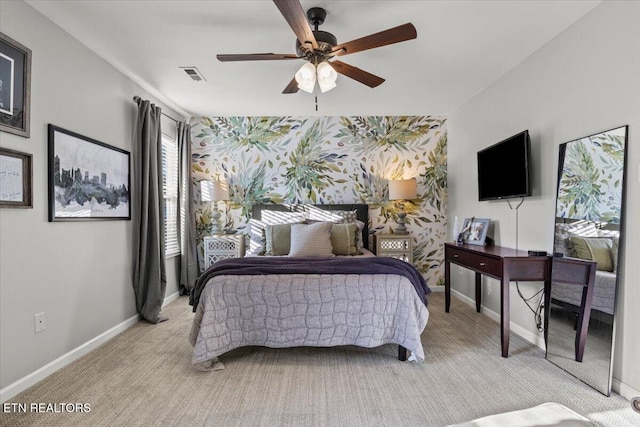 carpeted bedroom featuring baseboards, visible vents, and ceiling fan