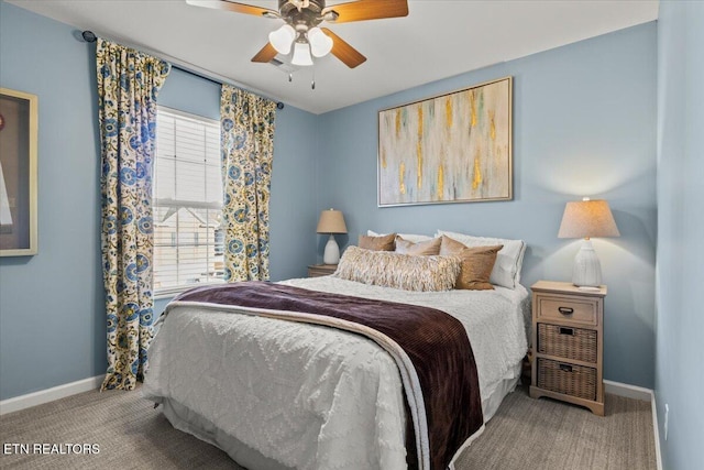 carpeted bedroom with baseboards and a ceiling fan