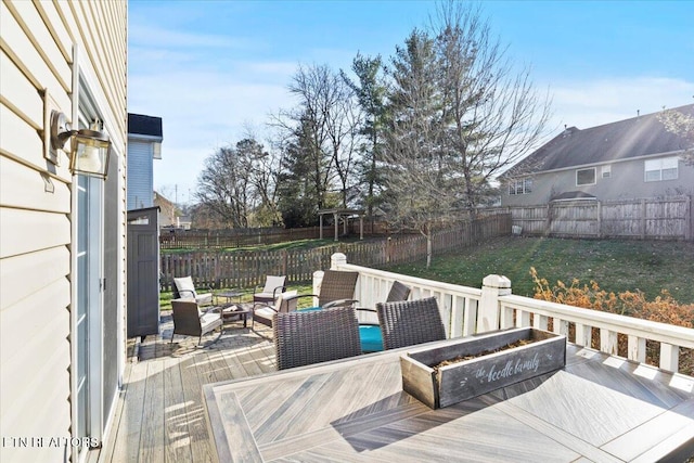 deck with an outdoor living space with a fire pit, a yard, and a fenced backyard