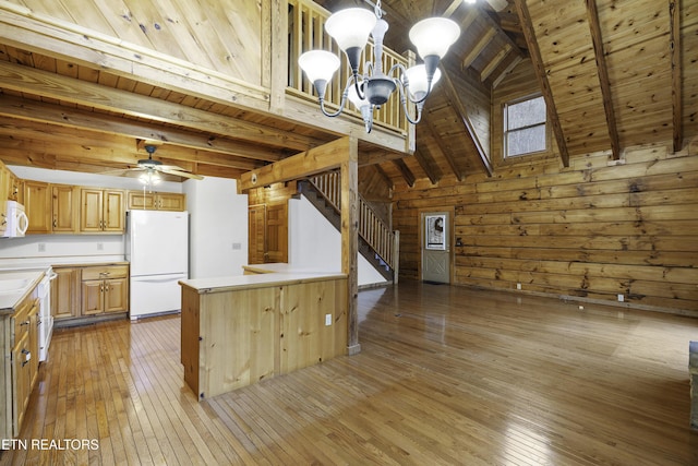 kitchen with white appliances, light countertops, light wood-style floors, and wooden ceiling