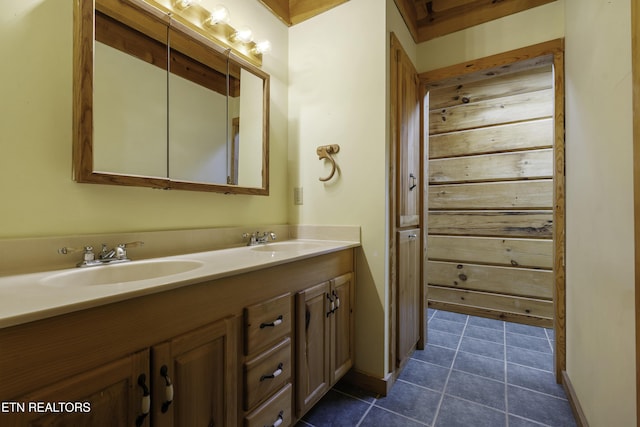 bathroom with tile patterned flooring, double vanity, and a sink