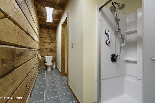 full bath featuring wood walls, toilet, a stall shower, wooden ceiling, and tile patterned floors