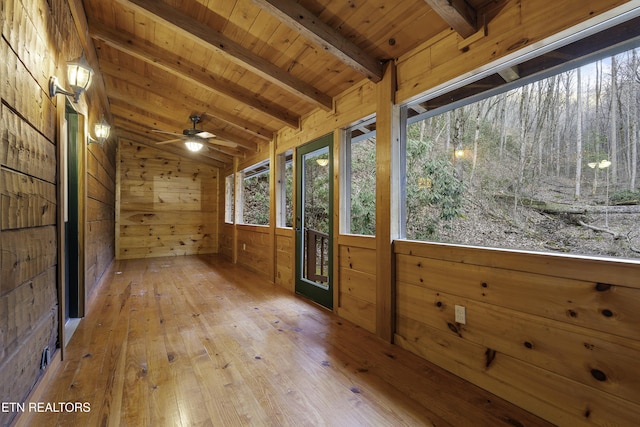 unfurnished sunroom featuring wood ceiling, lofted ceiling with beams, and ceiling fan