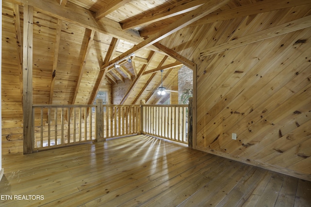 bonus room featuring a ceiling fan, hardwood / wood-style flooring, wooden walls, wooden ceiling, and vaulted ceiling with beams