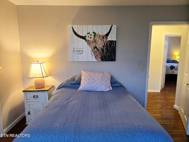 bedroom featuring dark wood finished floors and baseboards