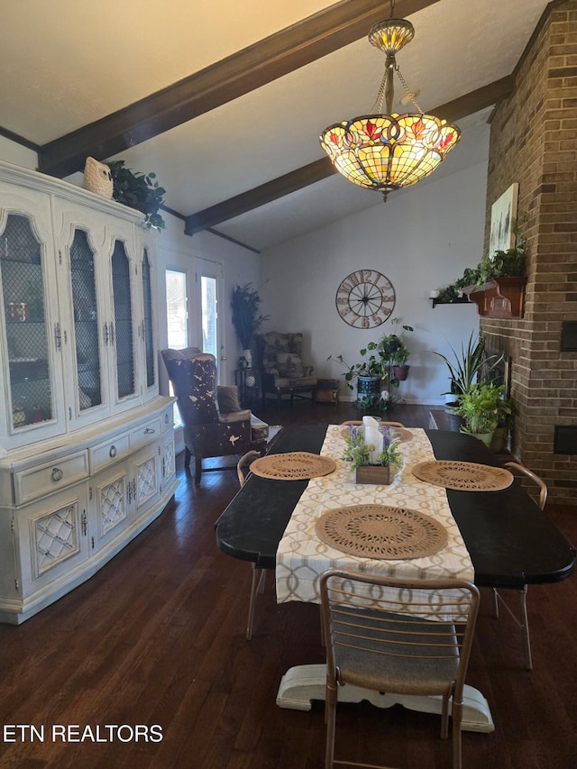 dining room with a fireplace, lofted ceiling with beams, and wood finished floors